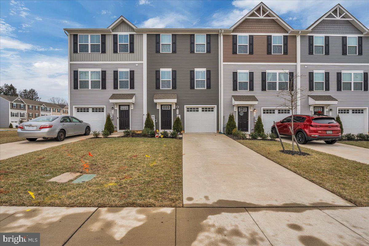 a front view of a residential apartment building with a yard