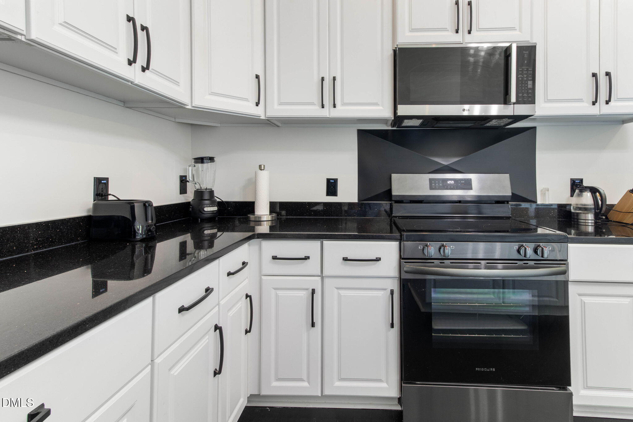 1300 Atlantic Street East Wilson, NC 27893 - Photo 26 of 28 a kitchen with white cabinets and appliances
