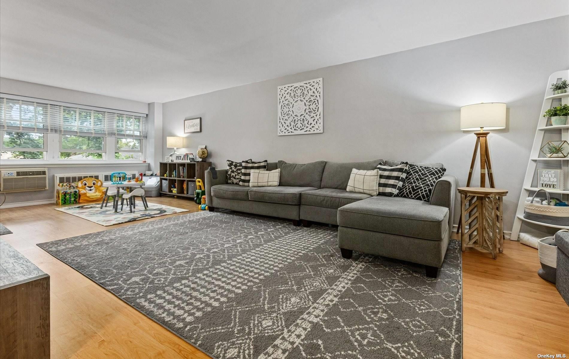 30 Pearsall Avenue, Unit 1J Glen Cove, NY 11542 - Photo 1 of 1 a living room with furniture and wooden floor