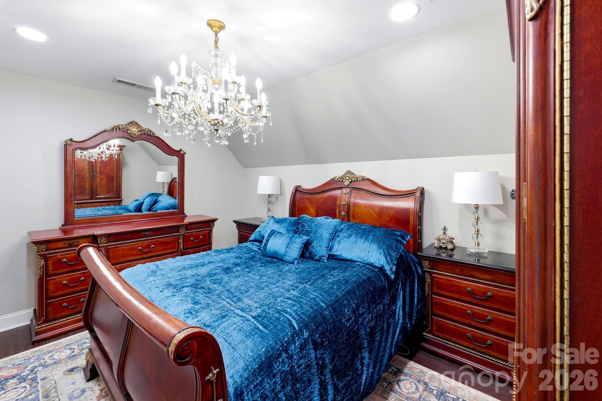 327 Sherry Street Rutherfordton, NC 28139 - Photo 19 of 22 a bedroom with a bed and a chandelier