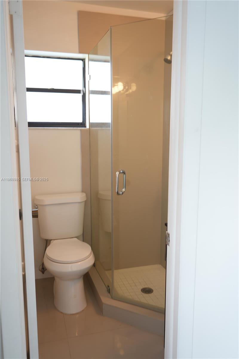2800 South University Drive, Unit 2A Davie, FL 33328 - Photo 11 of 23 a bathroom with a toilet and a shower