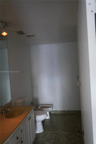 a bathroom with a sink and toilet