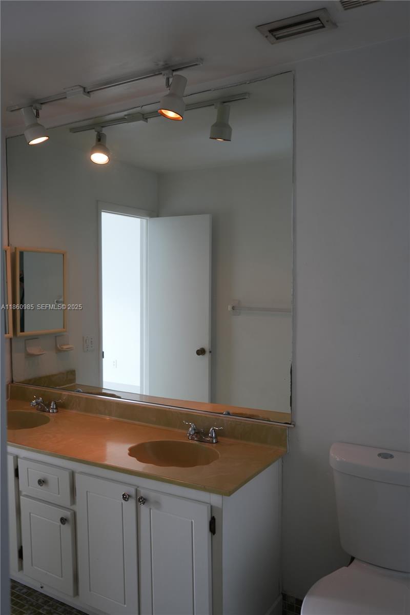 2800 South University Drive, Unit 2A Davie, FL 33328 - Photo 17 of 23 a bathroom with a granite countertop sink and a toilet