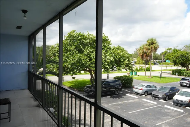 a view of a patio with table and chairs potted plants with sky view