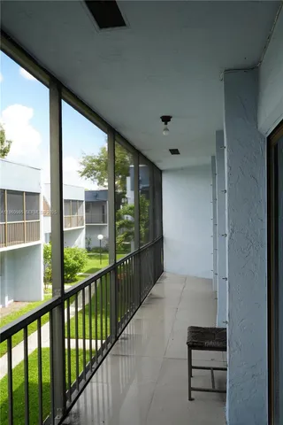 a view of a balcony with chairs