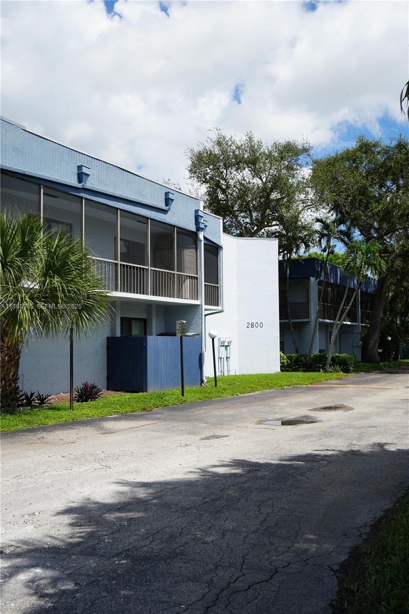 2800 South University Drive, Unit 2A Davie, FL 33328 - Photo 2 of 23 a front view of a house with a yard and garage