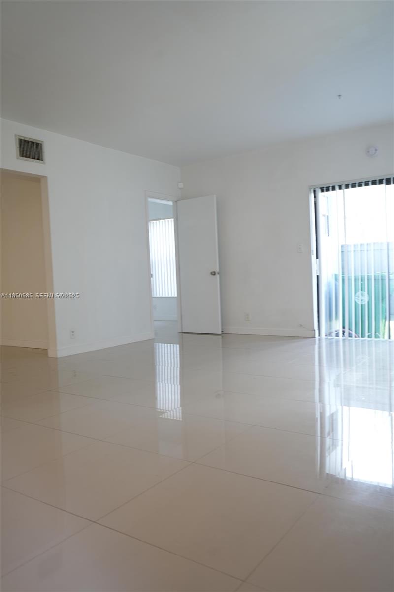 2800 South University Drive, Unit 2A Davie, FL 33328 - Photo 7 of 23 wooden floor in an empty room with a window
