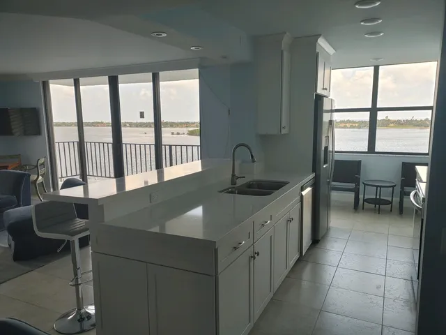 a kitchen with a table chairs and a sink