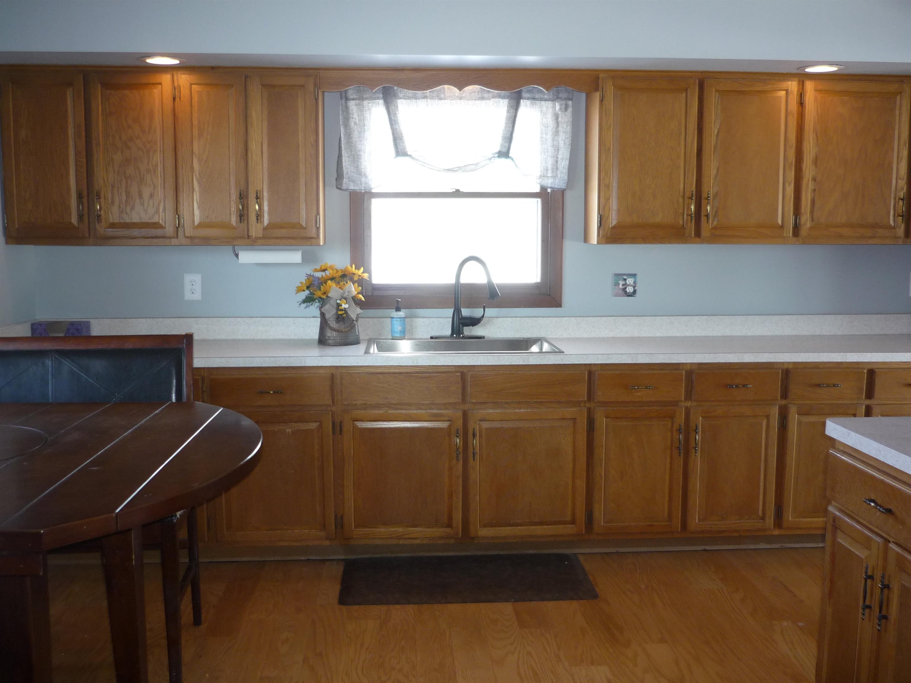 8539 North Pecatonica Road Pecatonica, IL 61063 - Photo 11 of 23 a kitchen with a sink cabinets and window