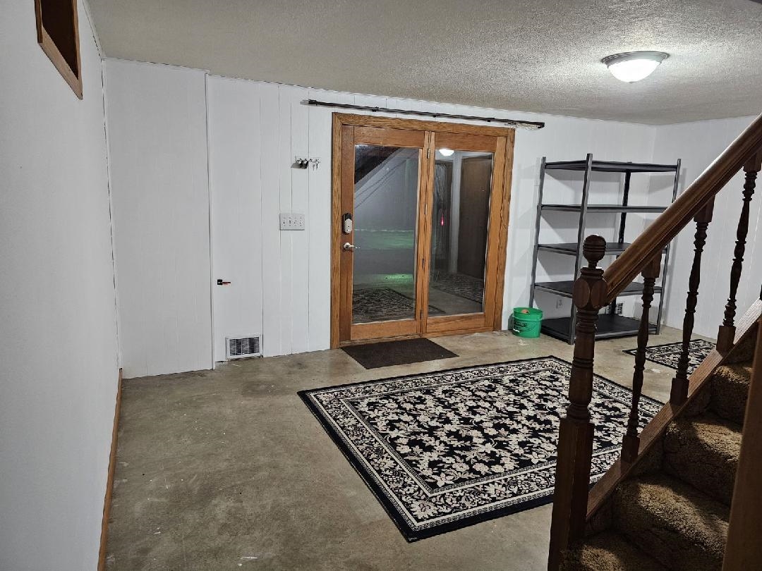 8539 North Pecatonica Road Pecatonica, IL 61063 - Photo 21 of 23 a view of a hallway with wooden floor and staircase
