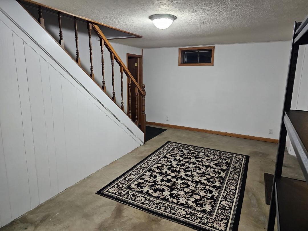 8539 North Pecatonica Road Pecatonica, IL 61063 - Photo 22 of 23 a view of a hallway with wooden floor and staircase