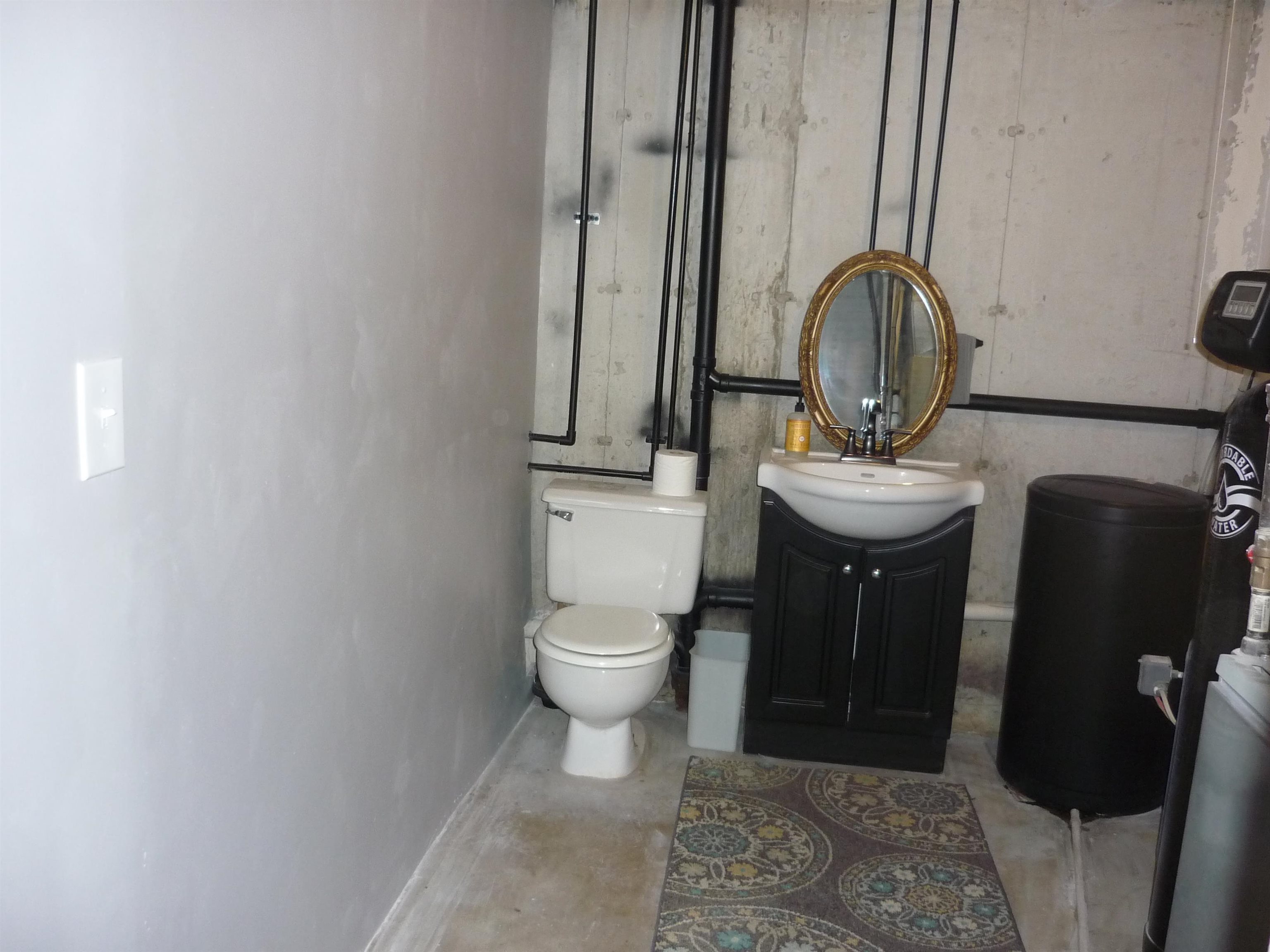 8539 North Pecatonica Road Pecatonica, IL 61063 - Photo 23 of 23 a bathroom with a toilet a sink and mirror