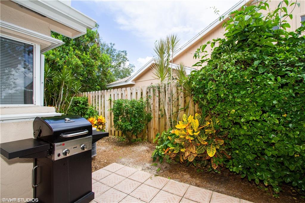 2608 Sailors Way, Unit 122 Naples, FL 34109 - Photo 13 of 47 a backyard of a house with outdoor seating