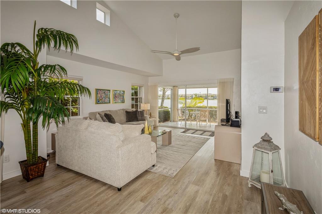2608 Sailors Way, Unit 122 Naples, FL 34109 - Photo 14 of 47 a living room with furniture and a large window