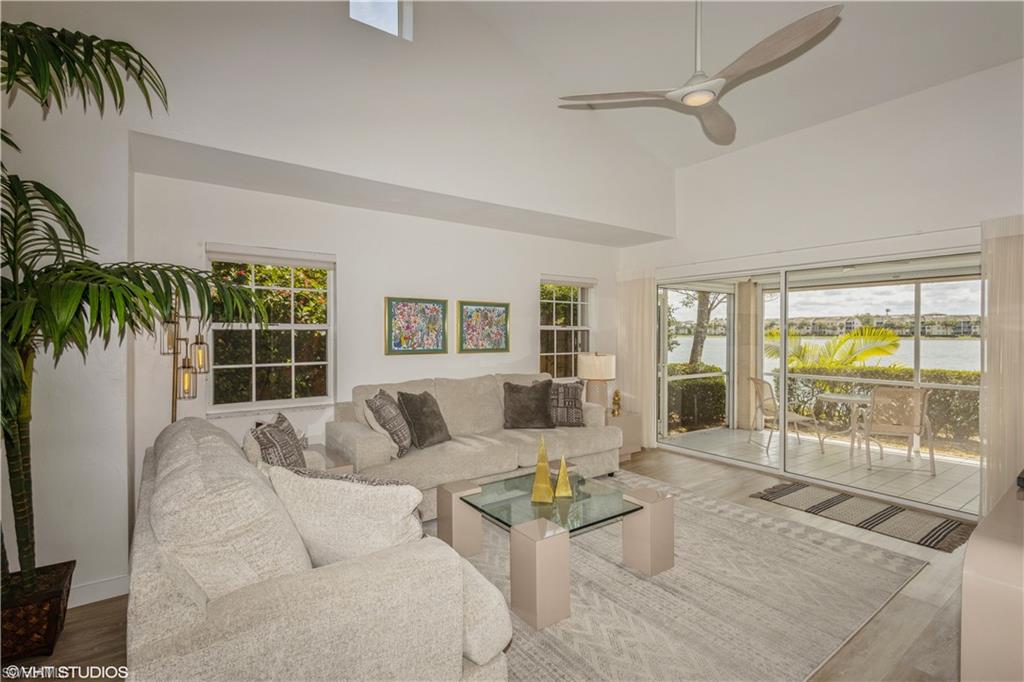 2608 Sailors Way, Unit 122 Naples, FL 34109 - Photo 16 of 47 a living room with furniture and a large window