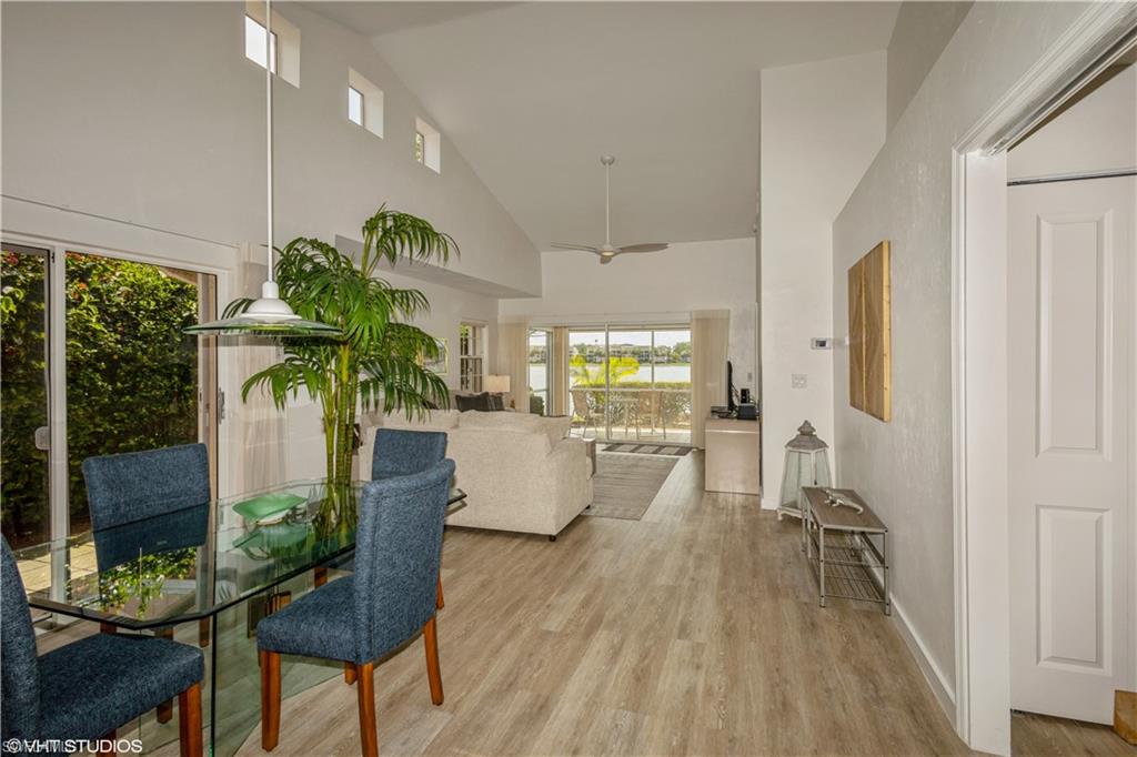 2608 Sailors Way, Unit 122 Naples, FL 34109 - Photo 18 of 47 a living room with furniture a potted plant and open kitchen view