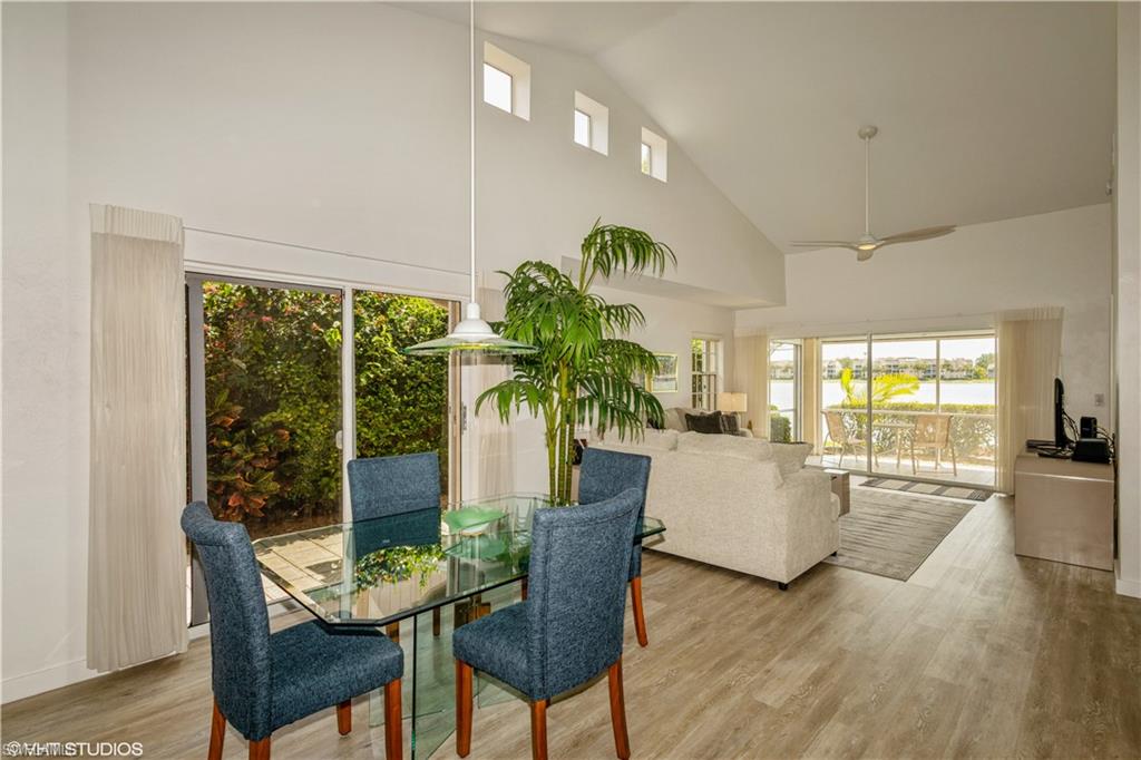 2608 Sailors Way, Unit 122 Naples, FL 34109 - Photo 19 of 47 a view of a dining room with furniture window and wooden floor