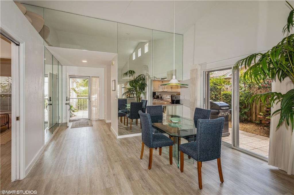 2608 Sailors Way, Unit 122 Naples, FL 34109 - Photo 24 of 47 a view of a dining room with furniture window and wooden floor