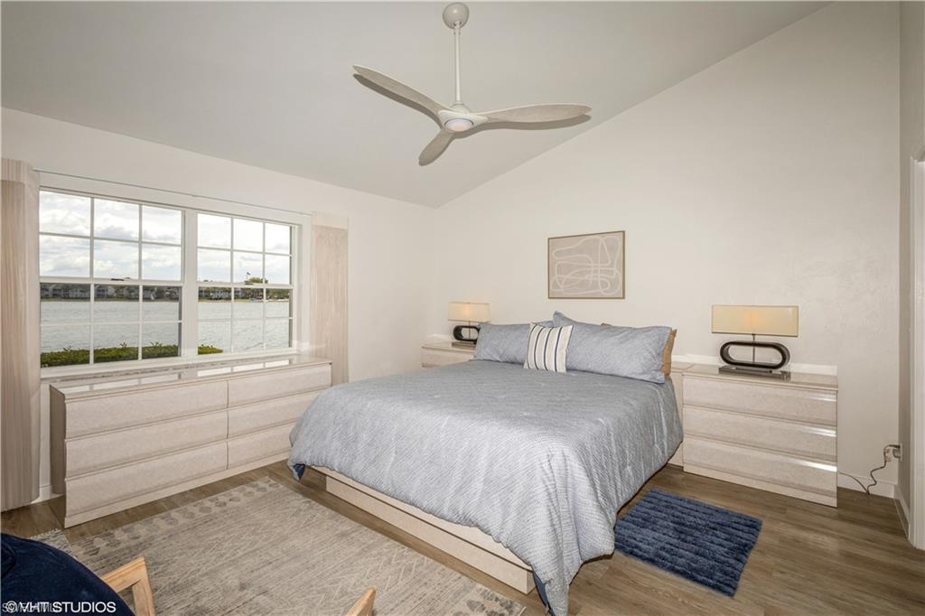 2608 Sailors Way, Unit 122 Naples, FL 34109 - Photo 26 of 47 a bedroom with a large bed and a large window