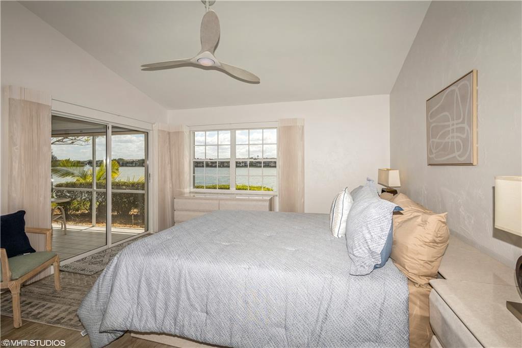 2608 Sailors Way, Unit 122 Naples, FL 34109 - Photo 27 of 47 a bedroom with a bed and a large window
