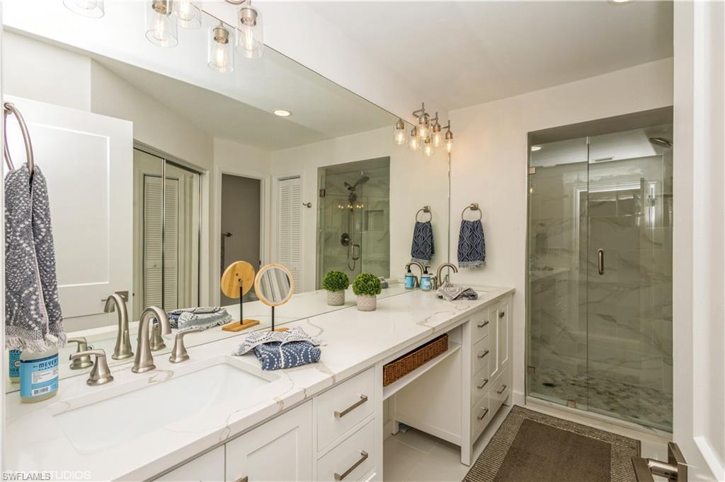 2608 Sailors Way, Unit 122 Naples, FL 34109 - Photo 28 of 47 a bathroom with a sink double vanity and a mirror