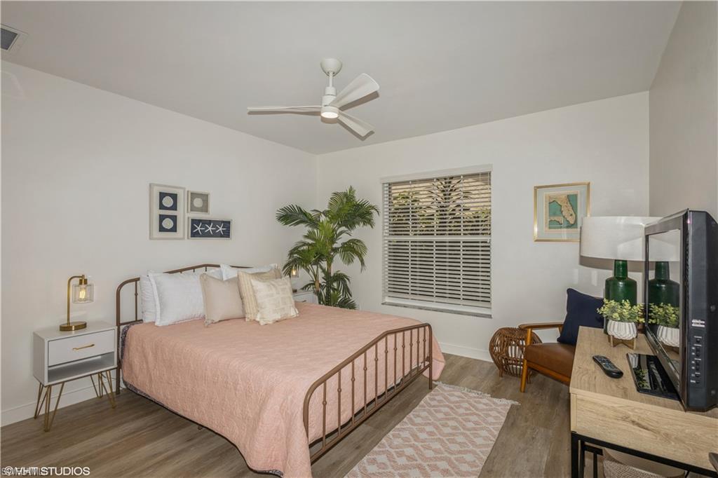 2608 Sailors Way, Unit 122 Naples, FL 34109 - Photo 31 of 47 a bedroom with a bed a couch and a window