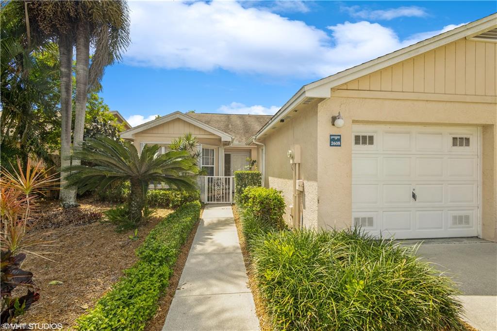 2608 Sailors Way, Unit 122 Naples, FL 34109 - Photo 34 of 47 a view of a pathway with a house in the background