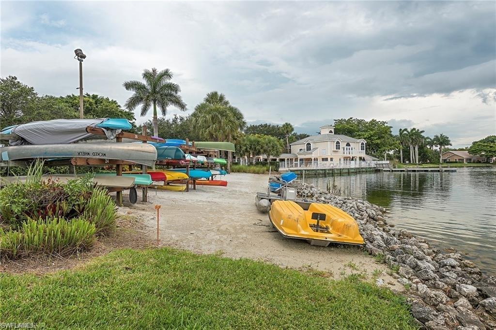 2608 Sailors Way, Unit 122 Naples, FL 34109 - Photo 39 of 47 a lake view with boat and palm trees
