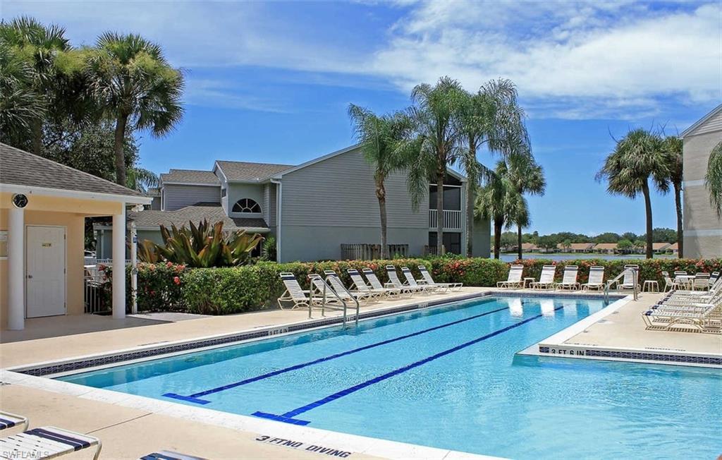 2608 Sailors Way, Unit 122 Naples, FL 34109 - Photo 40 of 47 a view of a swimming pool with a lounge chairs