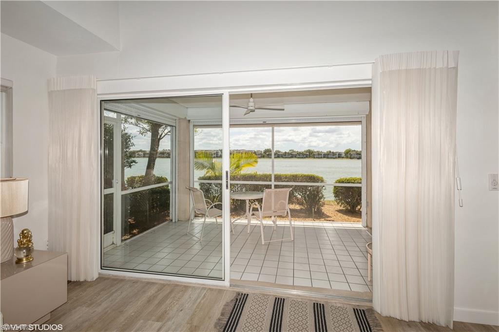 2608 Sailors Way, Unit 122 Naples, FL 34109 - Photo 5 of 47 wooden floor and dining room with furniture