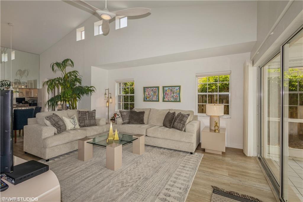 2608 Sailors Way, Unit 122 Naples, FL 34109 - Photo 9 of 47 a living room with furniture and a large window