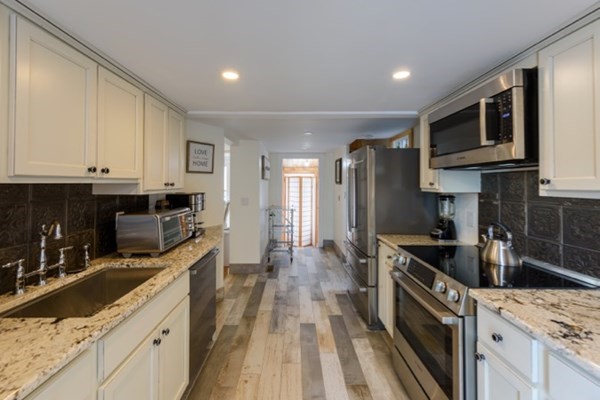 55 Samoset Avenue, Unit 1 Oak Bluffs, MA 02557 - Photo 3 of 10 a kitchen with stainless steel appliances granite countertop a stove a sink and a refrigerator