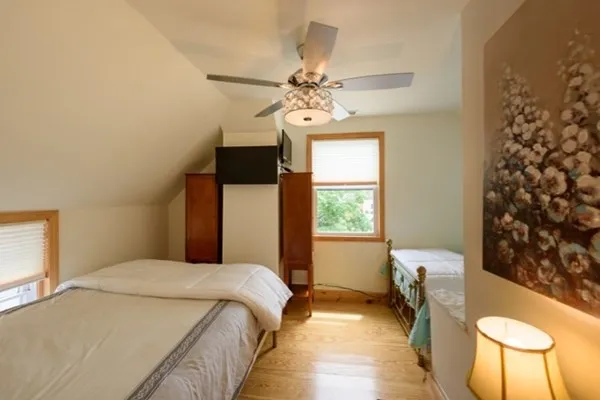 a bedroom with a bed dresser and a window