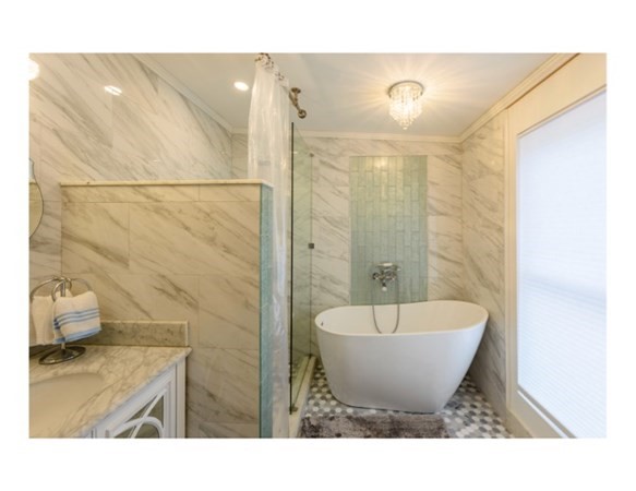 55 Samoset Avenue, Unit 1 Oak Bluffs, MA 02557 - Photo 8 of 10 a bathroom with a bathtub and shower