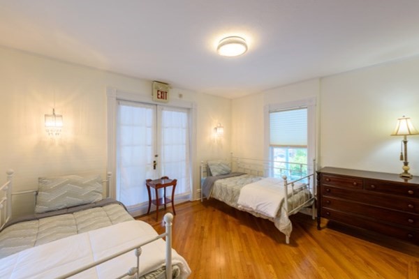 55 Samoset Avenue, Unit 1 Oak Bluffs, MA 02557 - Photo 9 of 10 a bedroom with a bed and wooden floor