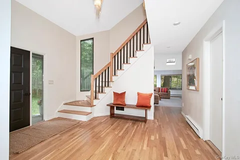 a view of entryway and hall with wooden floor