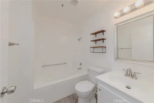 a bathroom with a sink toilet and vanity