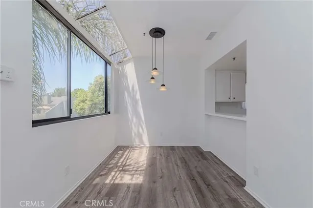 a view of hallway with wooden floor and staircase