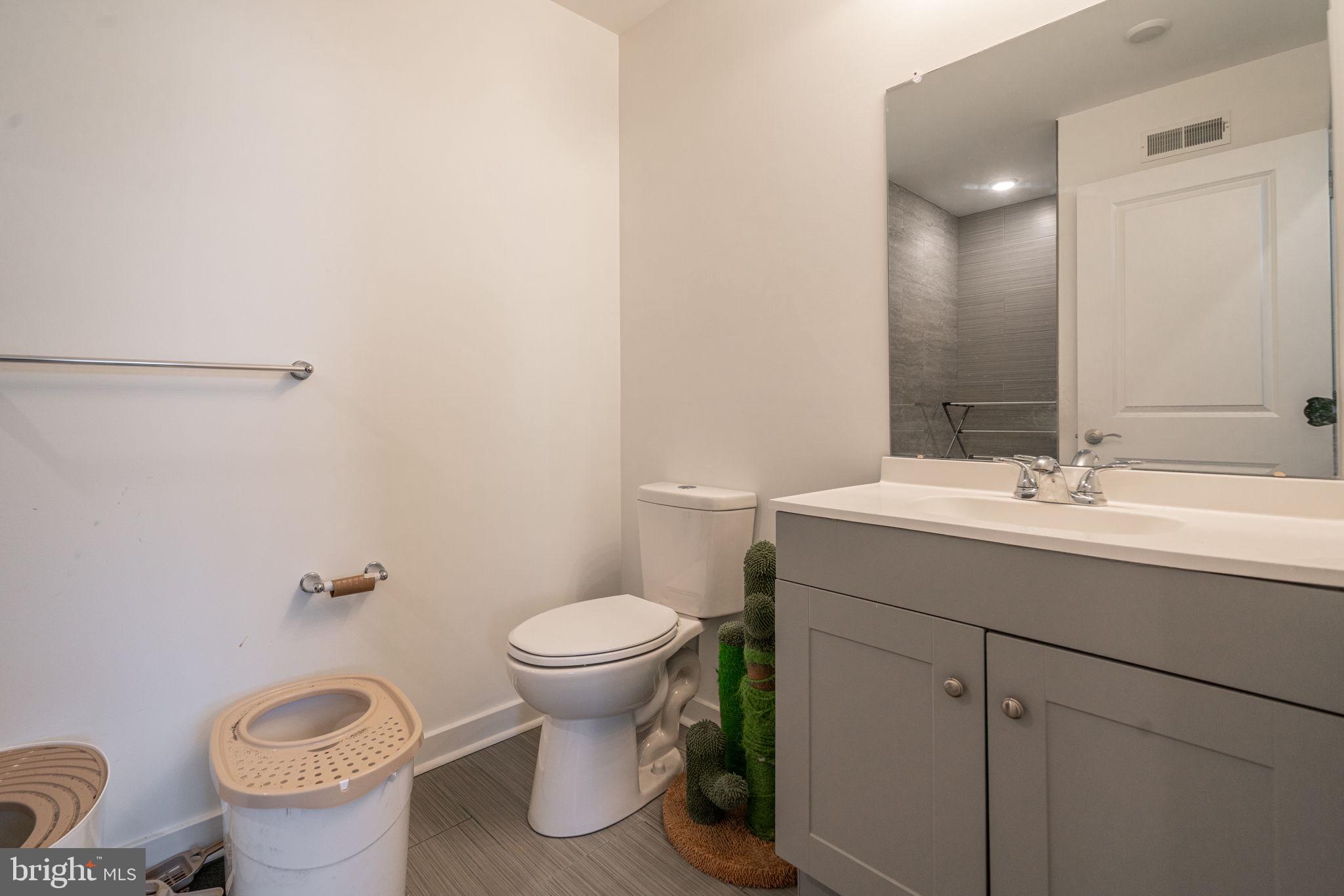 2613 Federal Street, Unit B Philadelphia, PA 19146 - Photo 15 of 21 a bathroom with a sink toilet and a mirror