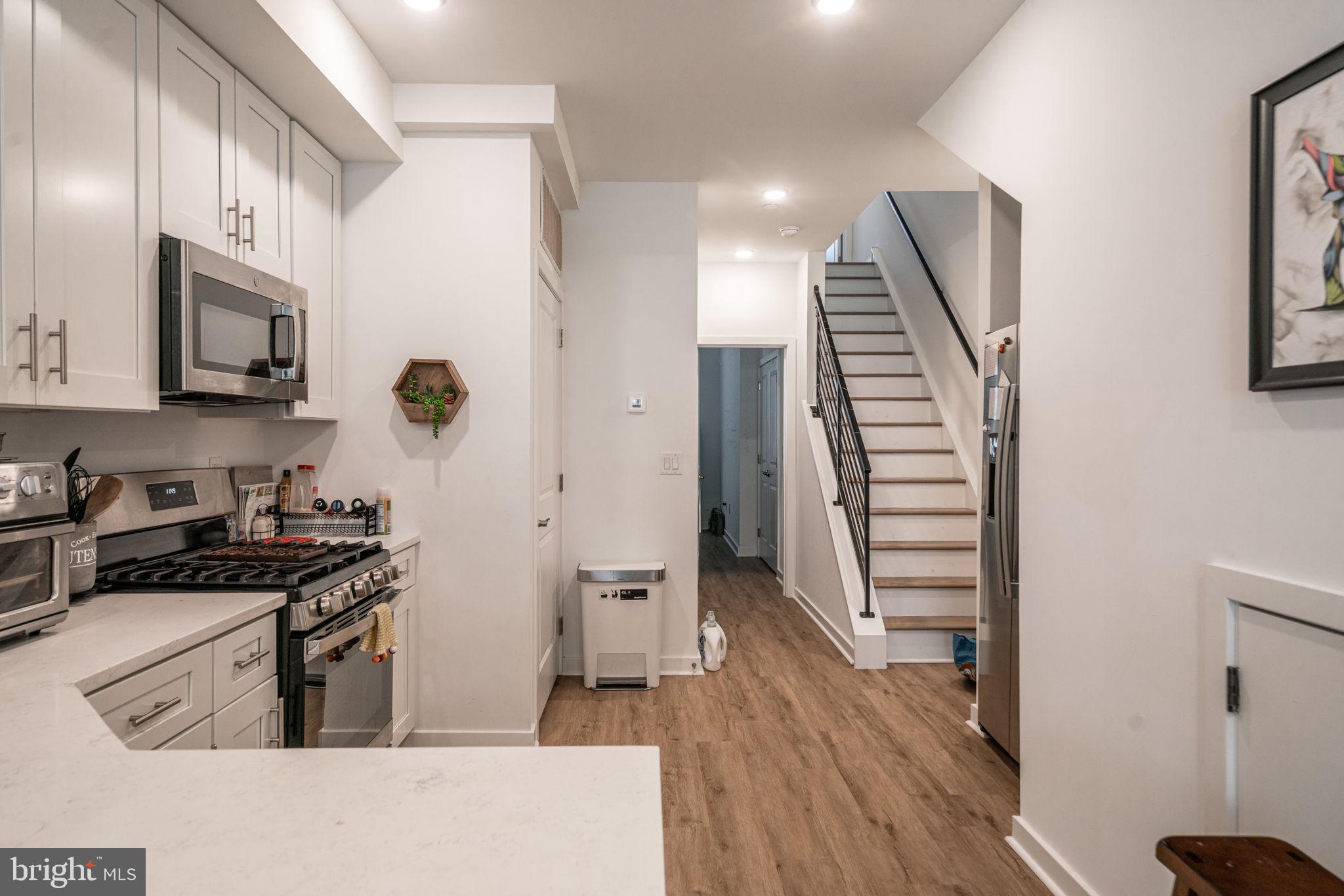 2613 Federal Street, Unit B Philadelphia, PA 19146 - Photo 7 of 21 a kitchen with a sink a refrigerator and a stove top oven