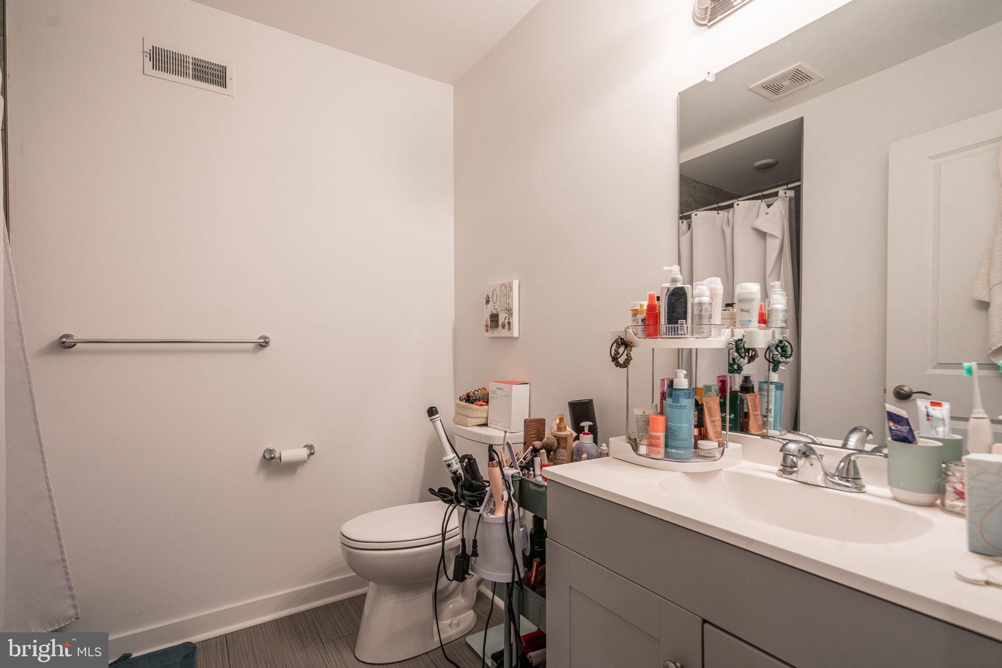 2613 Federal Street, Unit B Philadelphia, PA 19146 - Photo 9 of 21 a bathroom with a sink a toilet and shower
