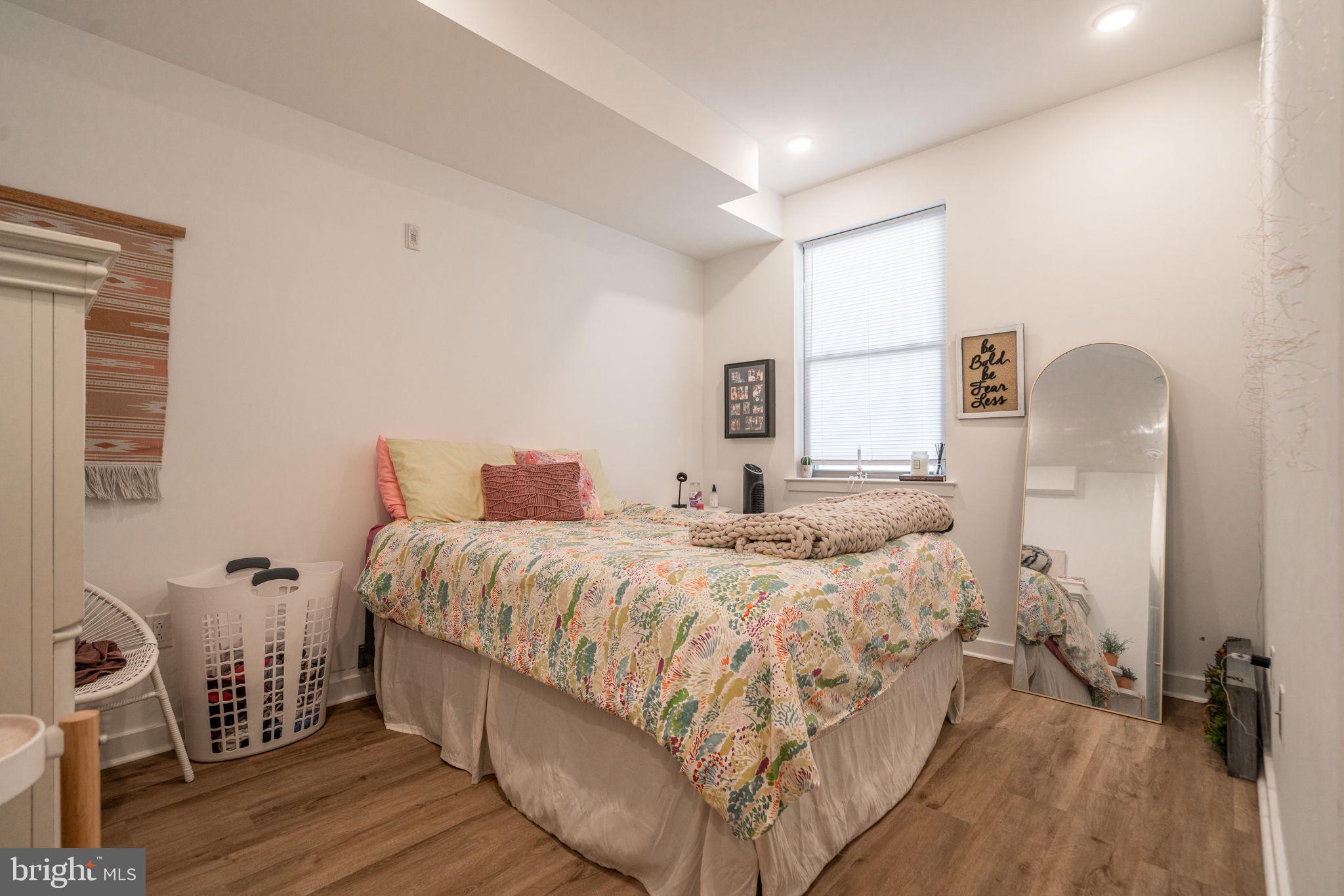 2613 Federal Street, Unit B Philadelphia, PA 19146 - Photo 10 of 21 a bedroom with a bed a mirror with wooden floor