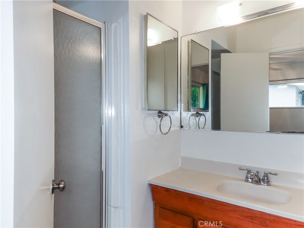 6688 Montclair Drive Riverside, CA 92504 - Photo 17 of 21 a bathroom with a sink and a mirror