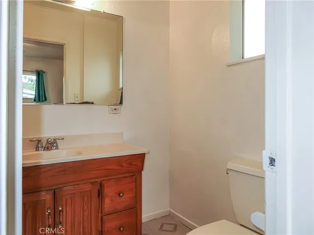 a bathroom with a sink a toilet and mirror