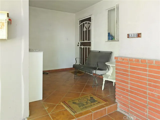 a room with gym equipment and wooden floor