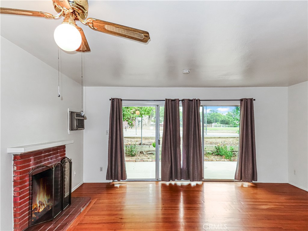 6688 Montclair Drive Riverside, CA 92504 - Photo 8 of 21 a view of an empty room with wooden floor and a window