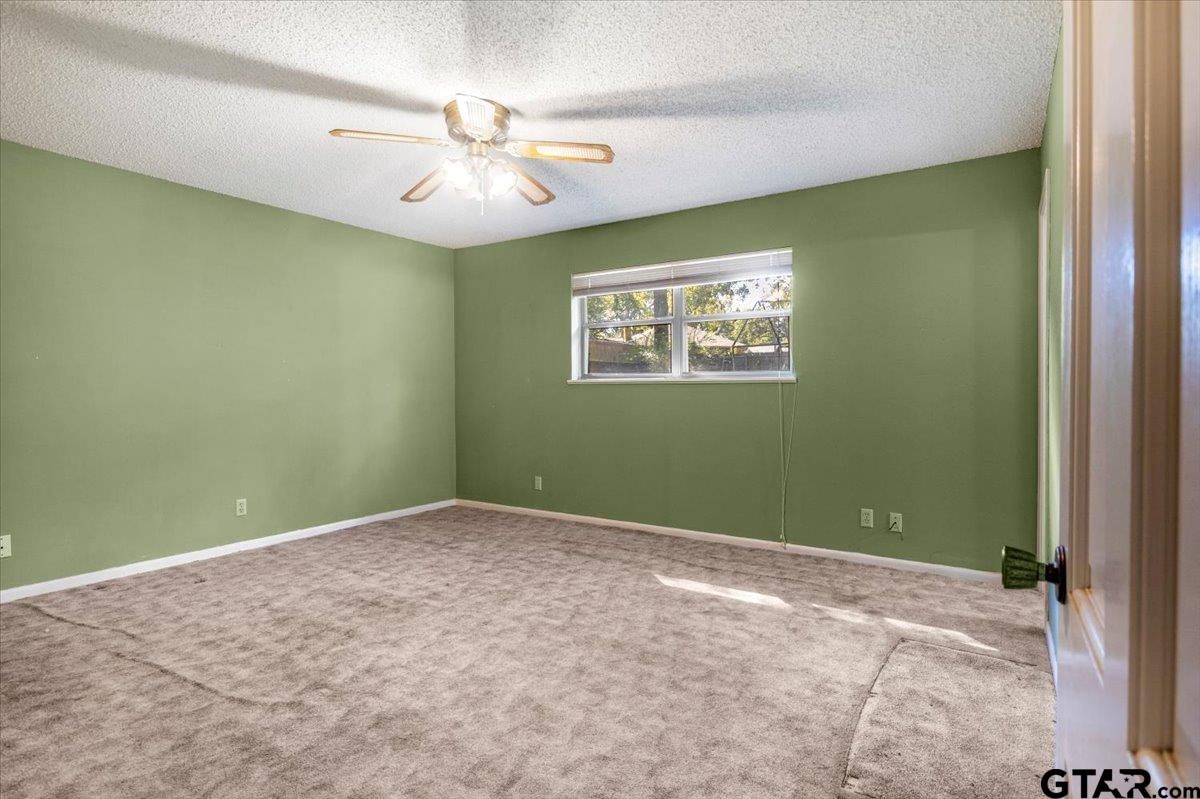 1302 Jeb Stuart Drive Tyler, TX 75703 - Photo 19 of 47 an empty room with windows and fan