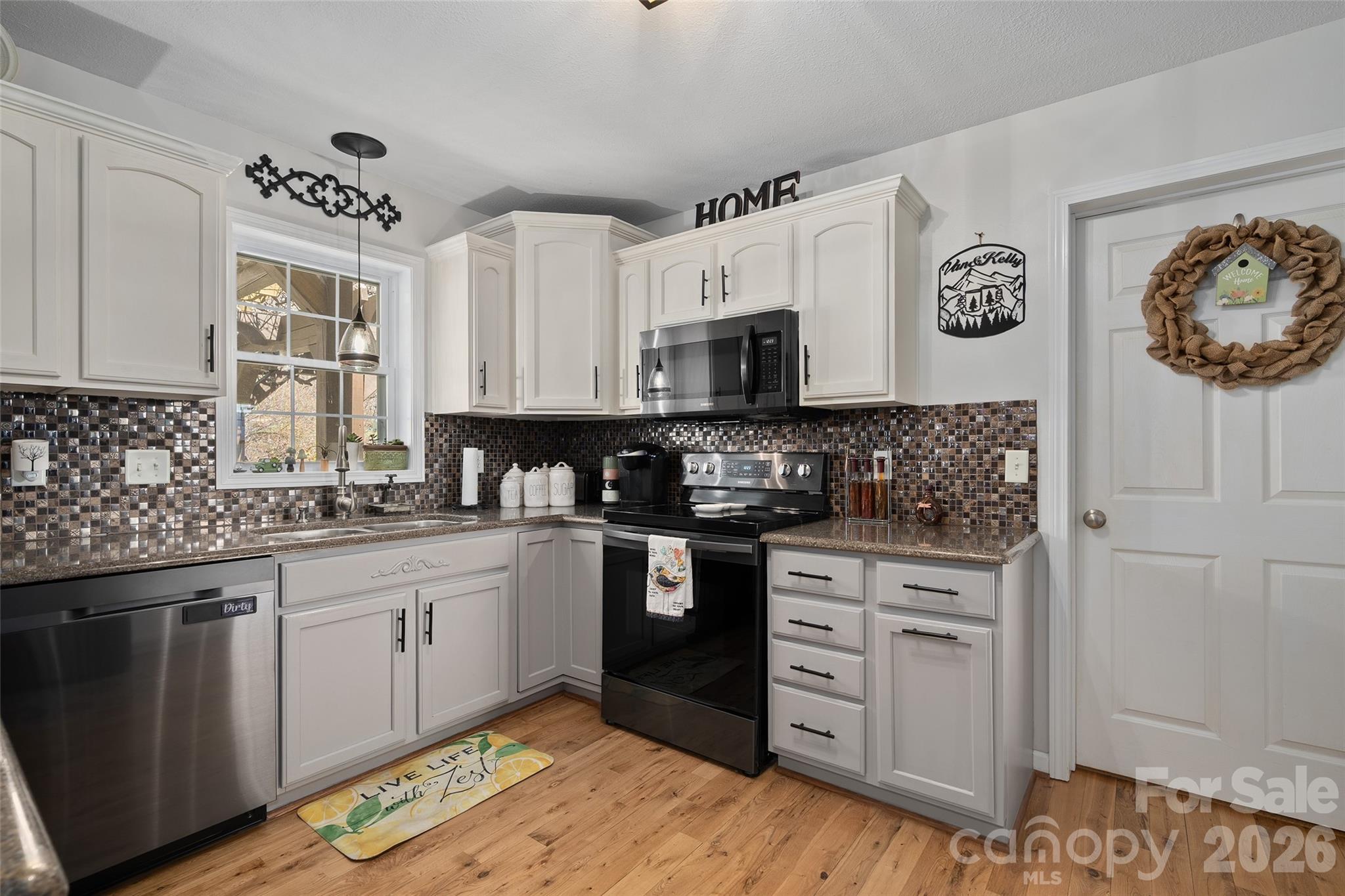 371 Ned Cove Road Waynesville, NC 28785 - Photo 15 of 44 a kitchen with stainless steel appliances granite countertop a stove and cabinets