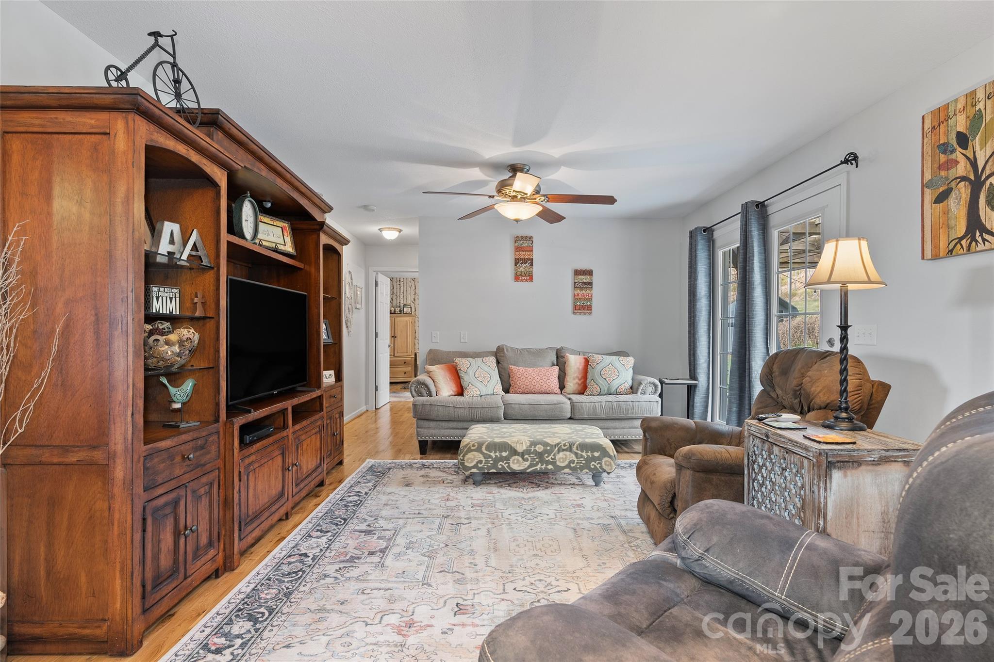 371 Ned Cove Road Waynesville, NC 28785 - Photo 19 of 44 a living room with furniture and a flat screen tv