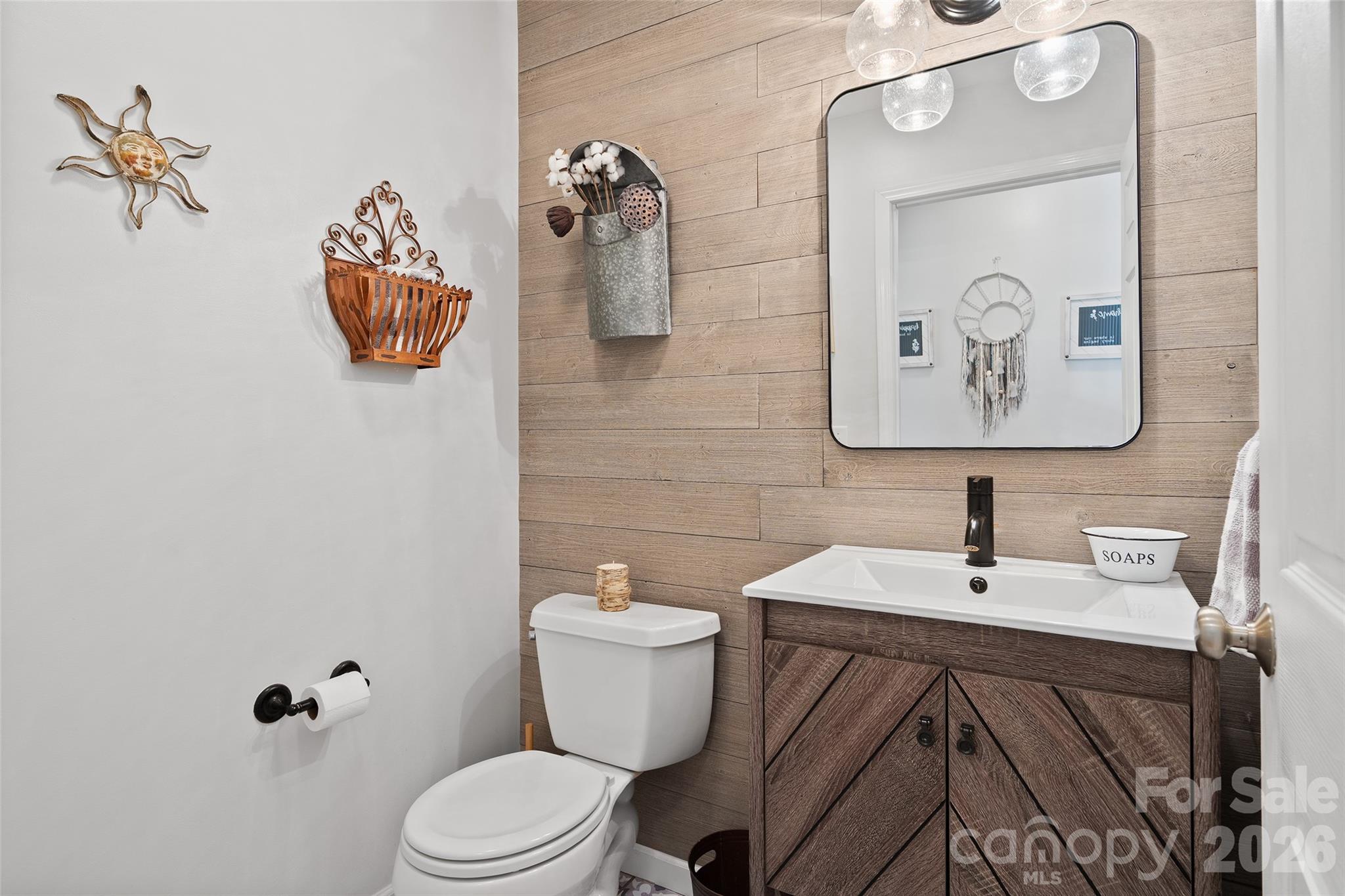 371 Ned Cove Road Waynesville, NC 28785 - Photo 21 of 44 a bathroom with a toilet sink and mirror